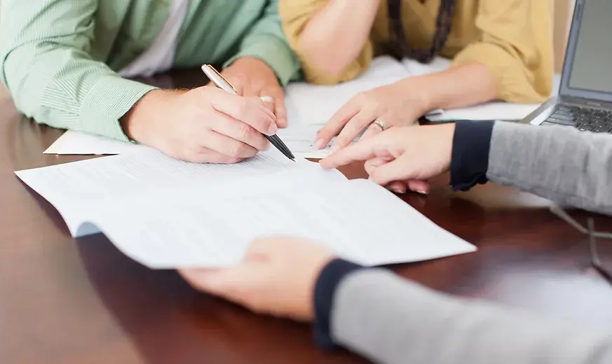 Lawyer and clients go over and sign paperwork